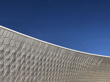 Tiled exterior of maat museum in belem, lisbon, portugal under a clear blue sky