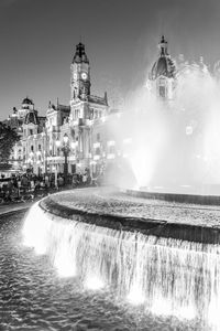 Water fountain amidst buildings in city