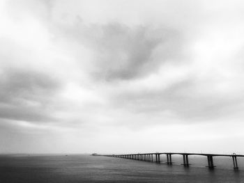 Bridge over sea against sky