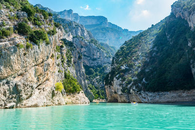 Scenic view of sea and mountains against sky