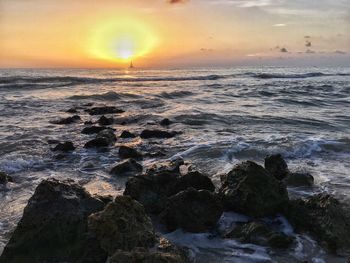 Scenic view of calm sea at sunset