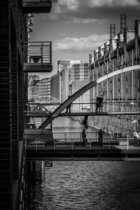 Bridge over river against buildings in city