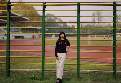 Full length portrait of woman standing outdoors