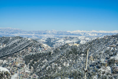 High angle view of townscape against clear blue sky