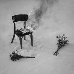 High angle view of burning empty chair on snow