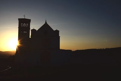 Silhouette building against sky during sunset