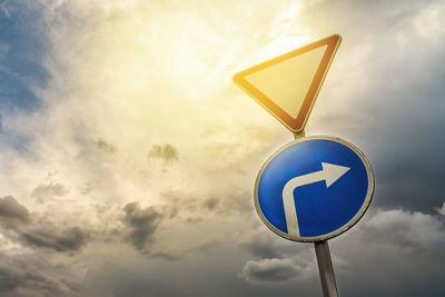 Low angle view of road sign against sky