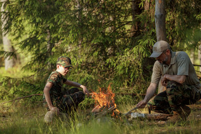 Father and son camping in forest