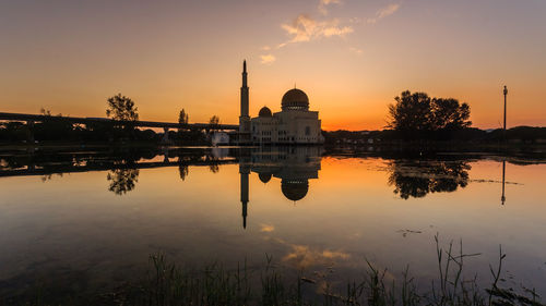 Reflection of building in lake during sunset