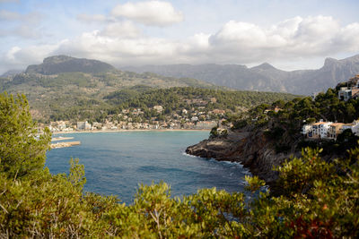 Scenic view of sea and mountains against sky