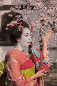 Woman in traditional clothing standing outdoors