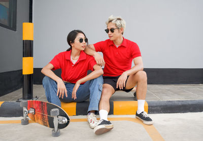 Young couple sitting outdoors