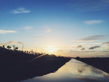 Scenic view of silhouette road against sky during sunset