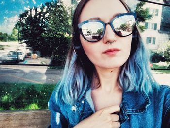 Close-up portrait of young woman wearing sunglasses