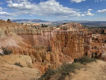 Rock formations on landscape against sky