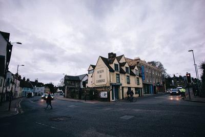 City street and buildings against sky