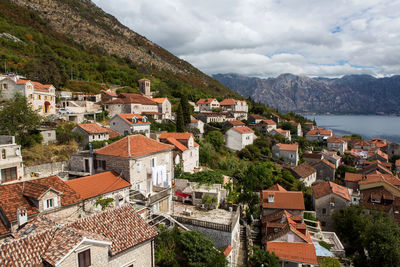 Perast, roofs of old houses in perast and bay with mountains in montenegro