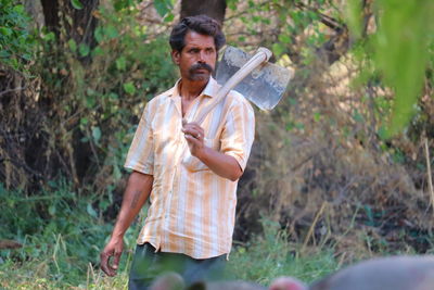 Portrait of a man holding plant