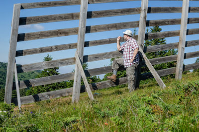 Man standing by staircase on field