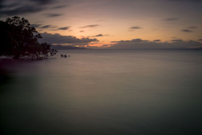 Scenic view of sea against sky at sunset