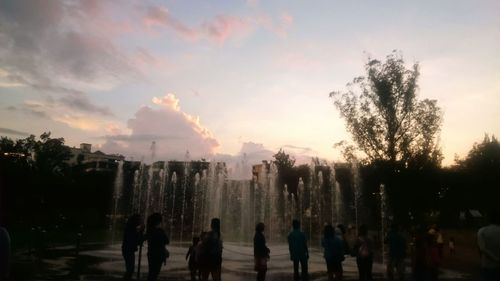 Silhouette people against sky during sunset