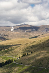 Scenic view of landscape against cloudy sky