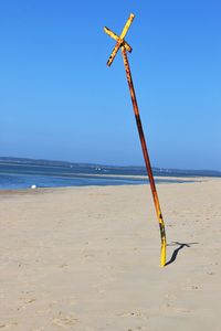 Scenic view of beach against clear blue sky