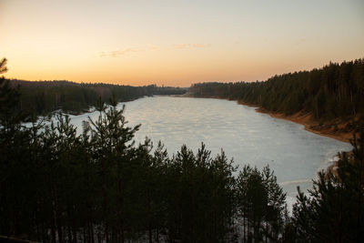 Scenic view of lake against sky at sunset