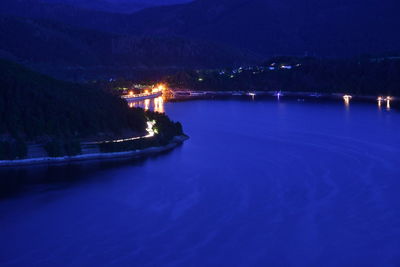 Scenic view of lake against sky at night