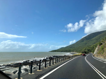 Road by sea against sky