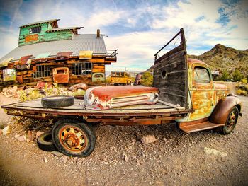 Abandoned vintage car against sky