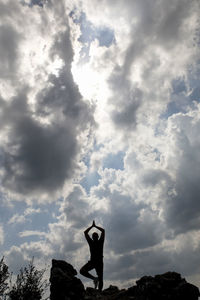 Low angle view of silhouette man standing against sky