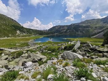 Scenic view of lake and mountains against sky