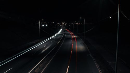High angle view of light trails on road at night