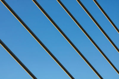 Low angle view of metallic structure against clear blue sky