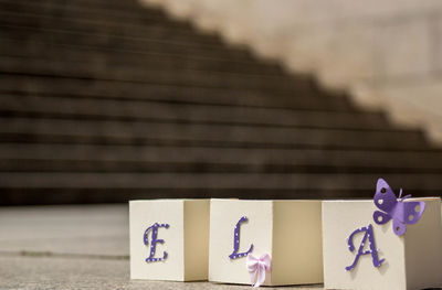 Close-up of alphabets on small boxes against steps