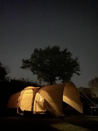 Tent on field against sky at night