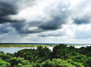 Scenic view of calm sea against cloudy sky