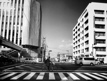 Vehicles on road along built structures