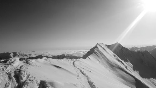 Low angle view of snow covered mountain against sky