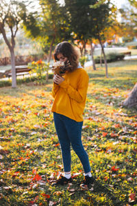 Side view of woman standing on field