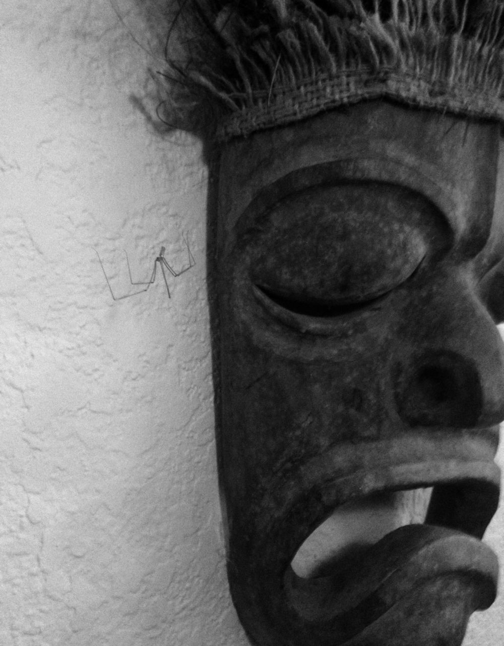 close-up, indoors, wall - building feature, art and craft, part of, art, one person, creativity, old, wall, focus on foreground, day, cropped, human representation, animal representation, built structure, front view