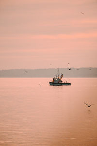 Fishing boat in baltic sea at sunrise