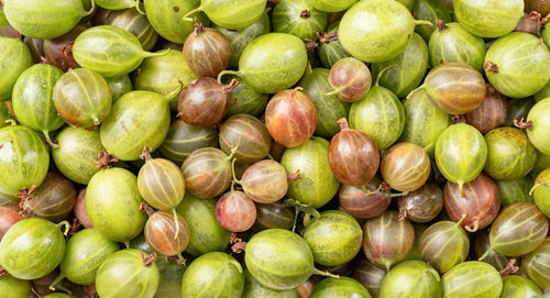 Fresh ripe gooseberries texture, flat lay