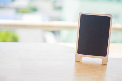 Close-up of small blackboard on table