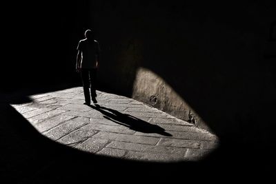 Shadow of people walking on tiled floor