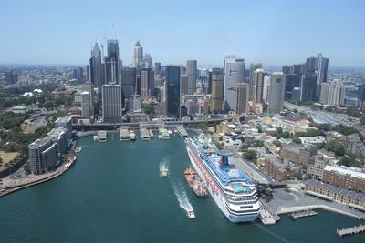 High angle view of buildings by sea against sky