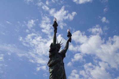 Low angle view of statue against cloudy sky