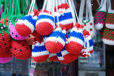 Close-up of multi colored crochets hanging for sale in market