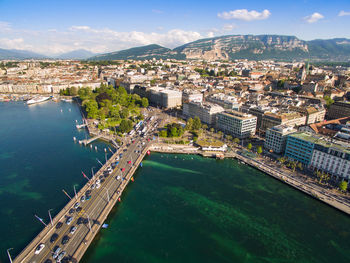 High angle view of city by sea against sky